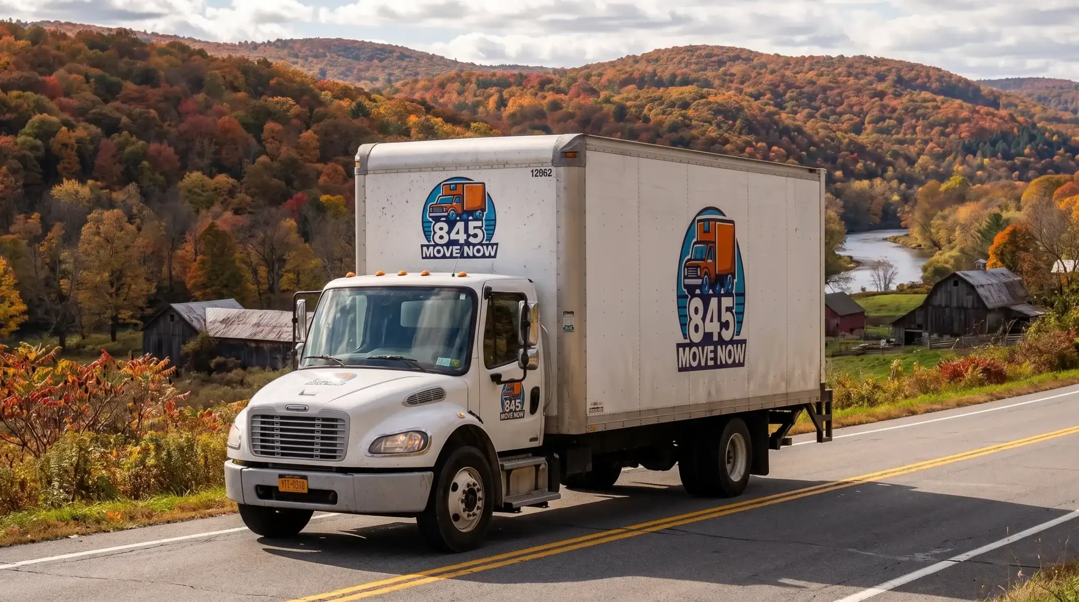 Moving truck driving through colorful autumn countryside