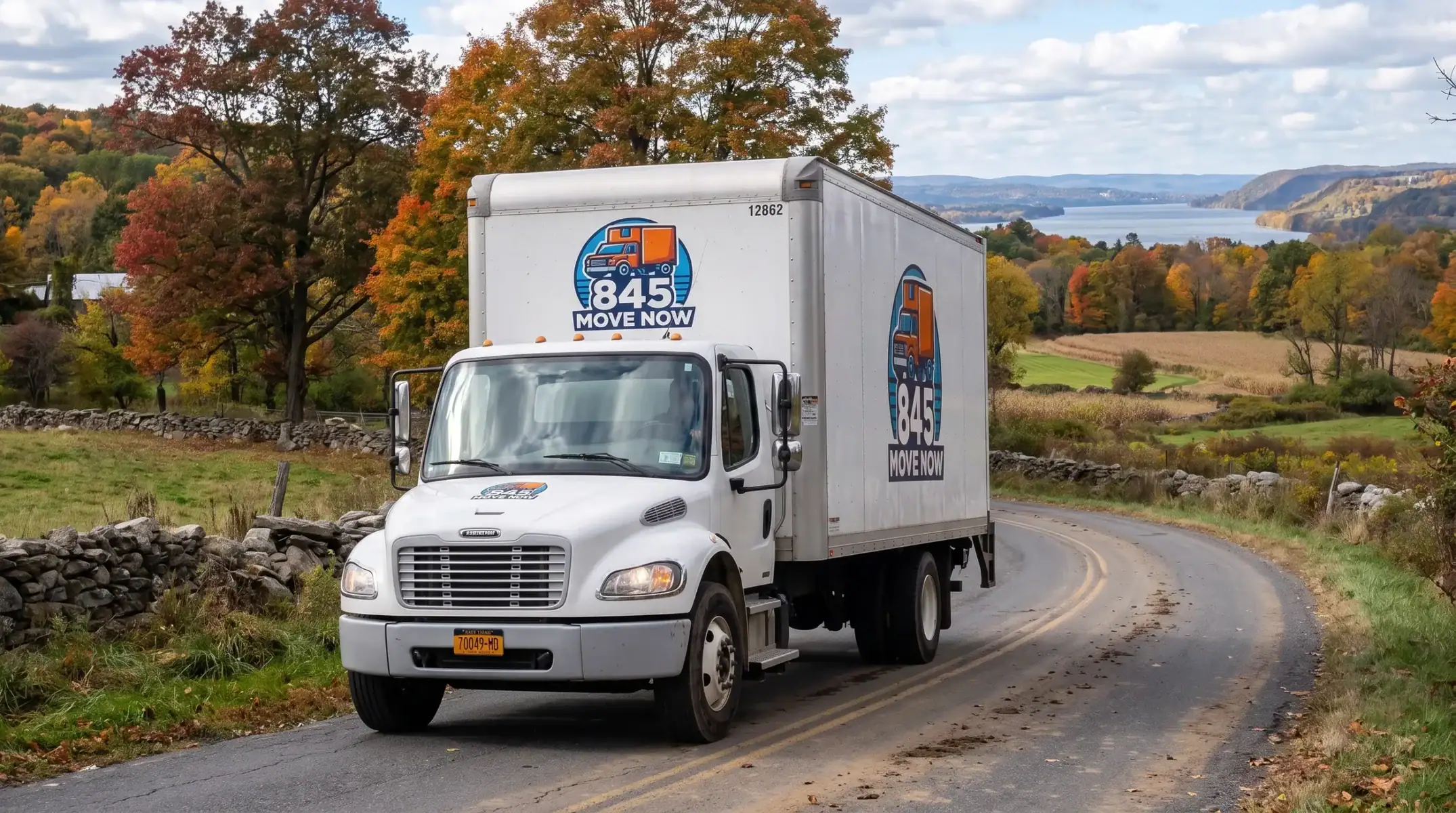 Moving truck driving through scenic autumn countryside
