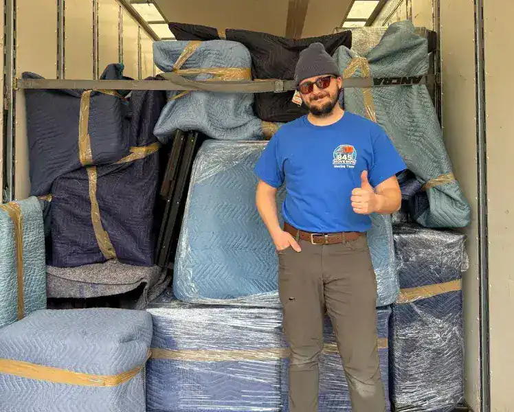Movers carefully handling boxes for an older couple in New Paltz, NY