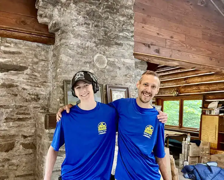 Movers in Plattekill, NY, two 845 Move Now movers inside a stone and timber home