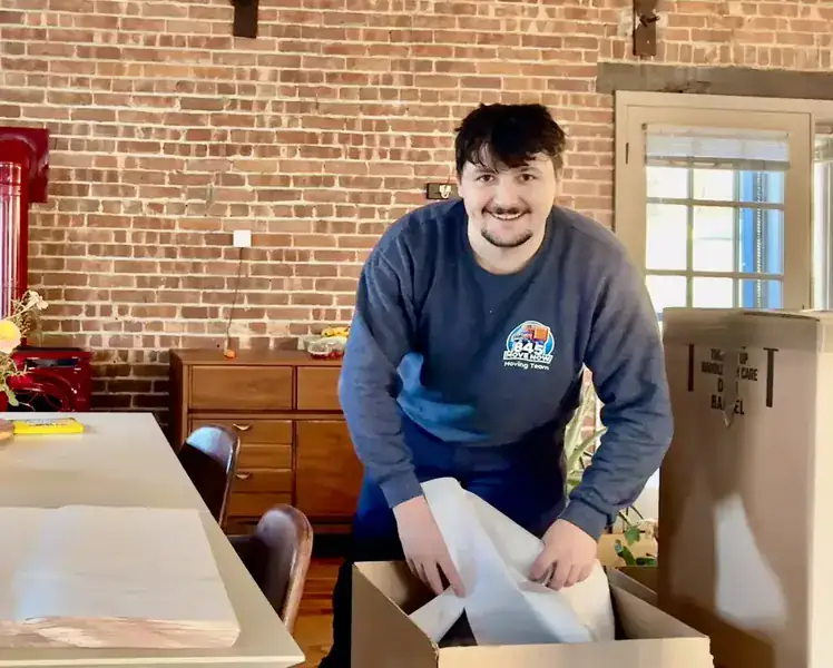 Packing services for Gardiner, NY moves, an 845 Move Now mover wrapping items in packing paper