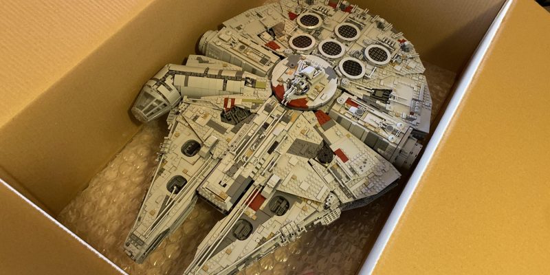 Lego Millennium Falcon model securely packed in a box with bubble wrap, illustrating effective packing strategies for moving Lego collections.