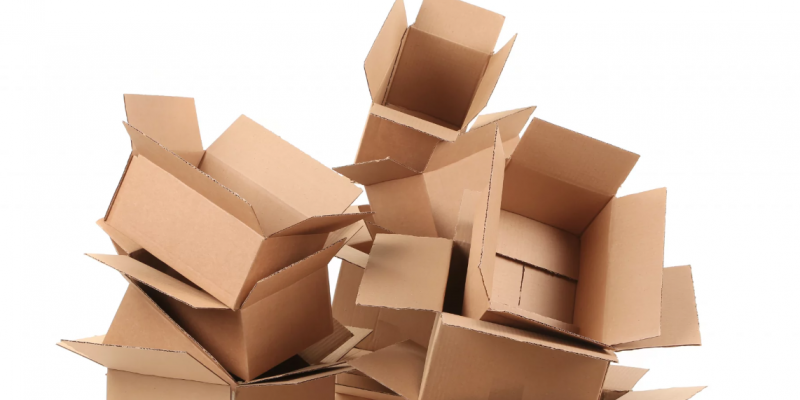 Stack of empty cardboard moving boxes, illustrating packing materials for relocation and emphasizing the importance of determining the right quantity for an organized move.