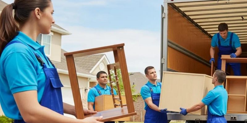 Professional movers loading furniture into a truck in a suburban neighborhood, showcasing local moving services by 845 Move Now in Wallkill, NY.